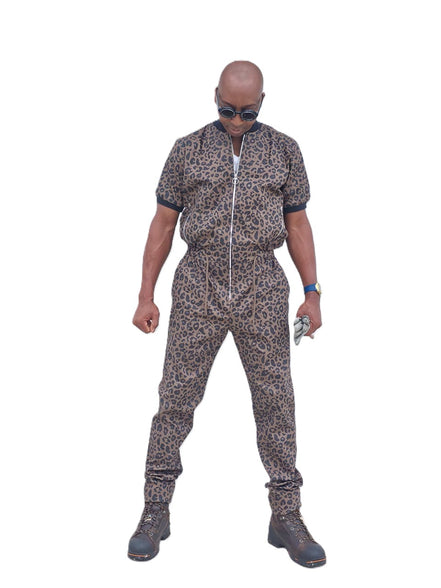 Short-sleeved jumpsuit featuring a brown and black animal print, a silver front zipper, and black ribbed cuffs