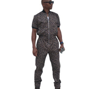 Short-sleeved jumpsuit featuring a brown and black animal print, a silver front zipper, and black ribbed cuffs