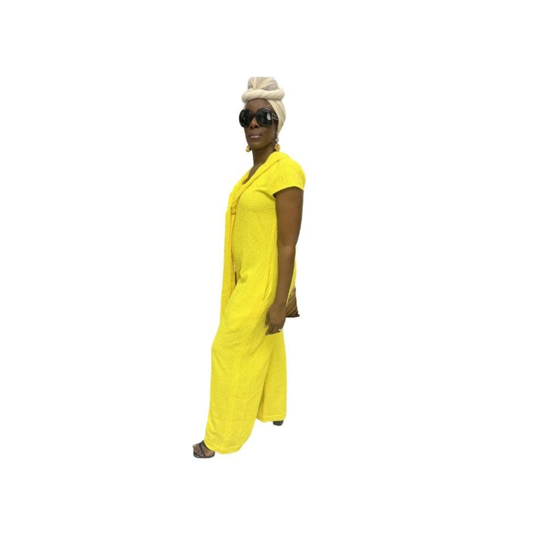 Jumpsuit featuring a sleeveless V-neckline, a prominent matching yellow neck tie, and long wide-leg trousers