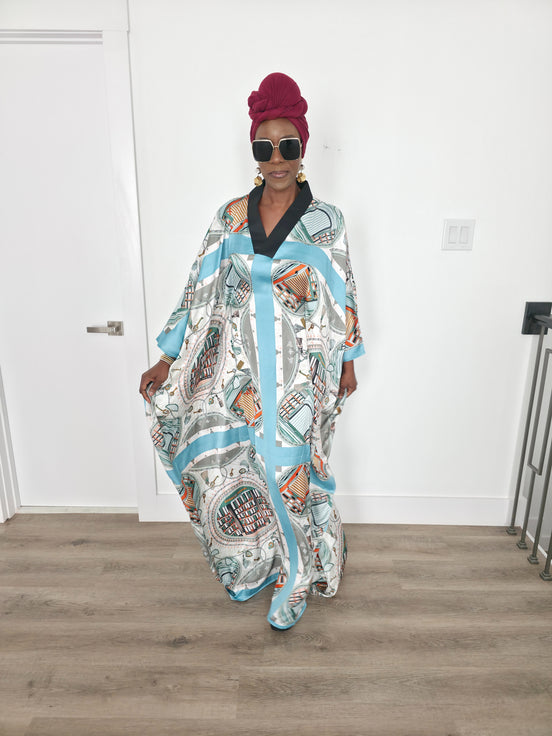 Aquatic Mosaic Boubou Kaftan featuring a teal and grey tile-patterned print with a structured black V-neck collar and flowing sleeves. Front View