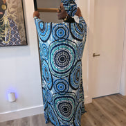Patterned Boubou Kaftan featuring a blue and turquoise concentric circular print, a solid black V-neckline, and a voluminous silhouette.