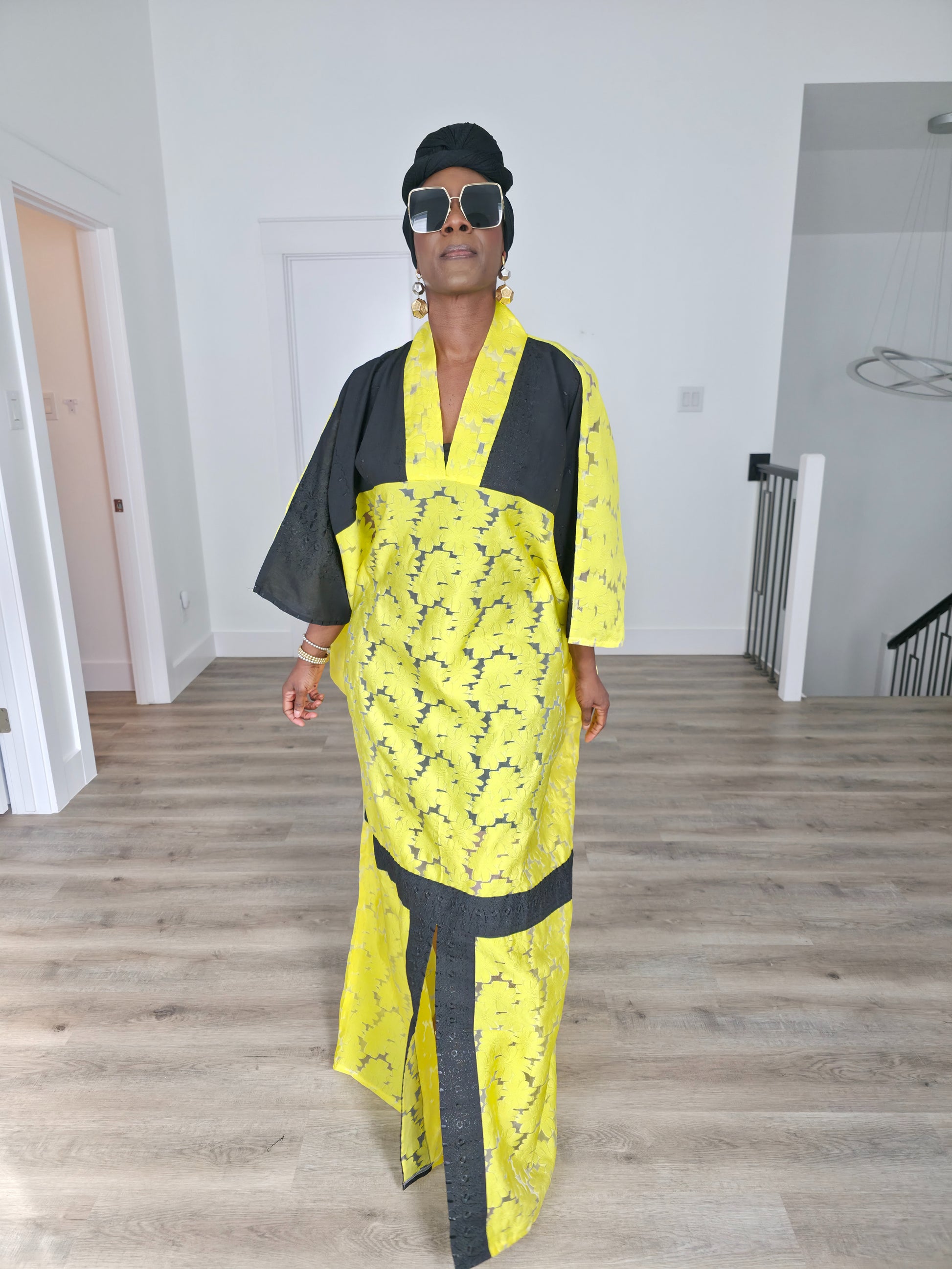 Bumblebee Boubou Kaftan in vibrant yellow textured fabric with bold black contrast panels and a matching black headwrap. Front View