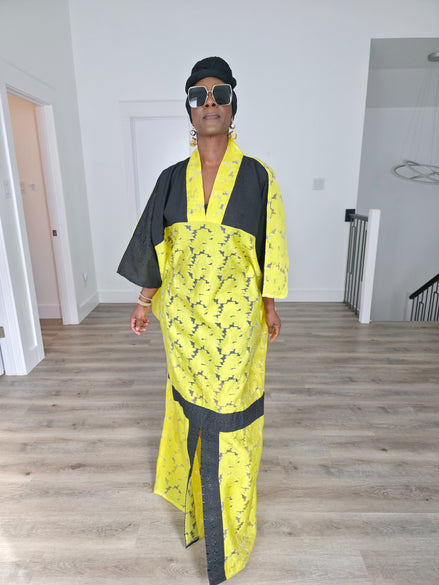 Bumblebee Boubou Kaftan in vibrant yellow textured fabric with bold black contrast panels and a matching black headwrap. Front View
