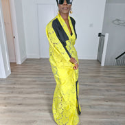 Bumblebee Boubou Kaftan in vibrant yellow textured fabric with bold black contrast panels and a matching black headwrap. Side View
