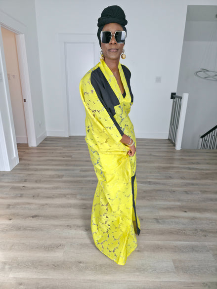 Bumblebee Boubou Kaftan in vibrant yellow textured fabric with bold black contrast panels and a matching black headwrap. Side View