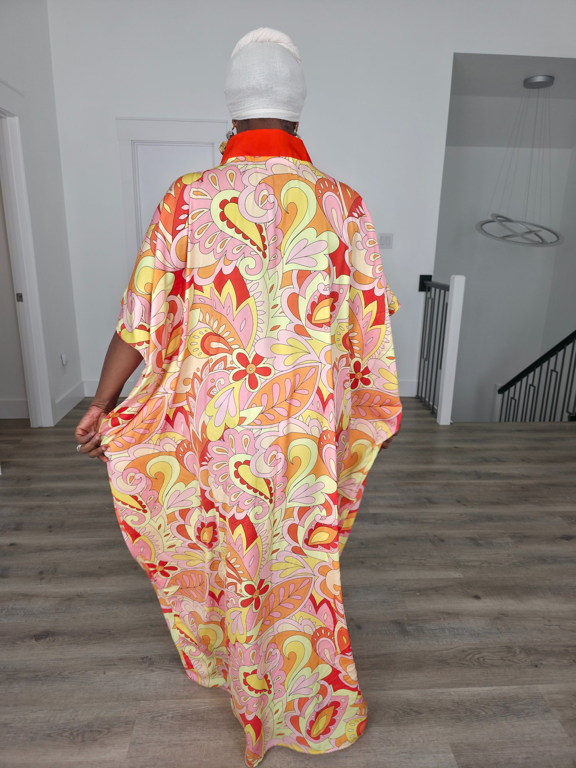 Citrus Sorbet Boubou Kaftan featuring a vibrant pink, orange, and yellow organic swirl pattern with a structured orange V-neck collar. Back View
