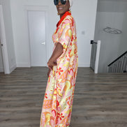 Citrus Sorbet Boubou Kaftan featuring a vibrant pink, orange, and yellow organic swirl pattern with a structured orange V-neck collar. Side Profile