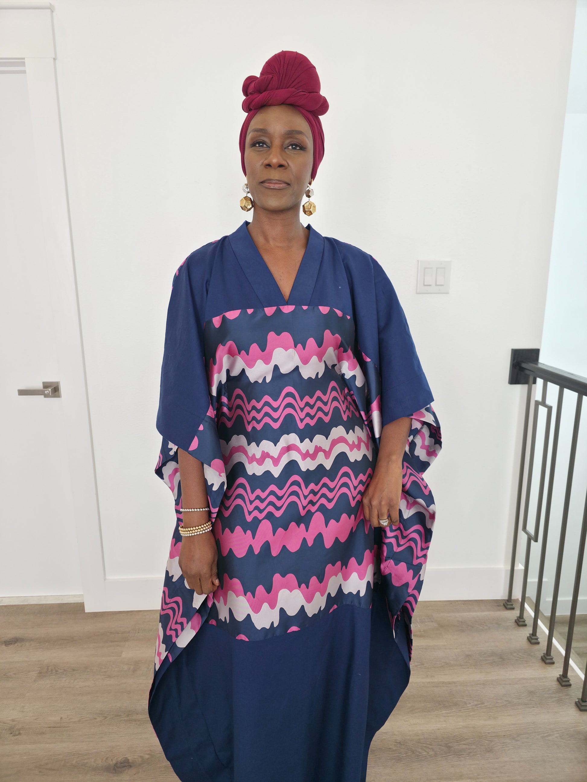 Cosmic Candy Boubou Kaftan in navy blue featuring a central horizontal panel with pink and lavender wavy patterns and a V-neck collar.