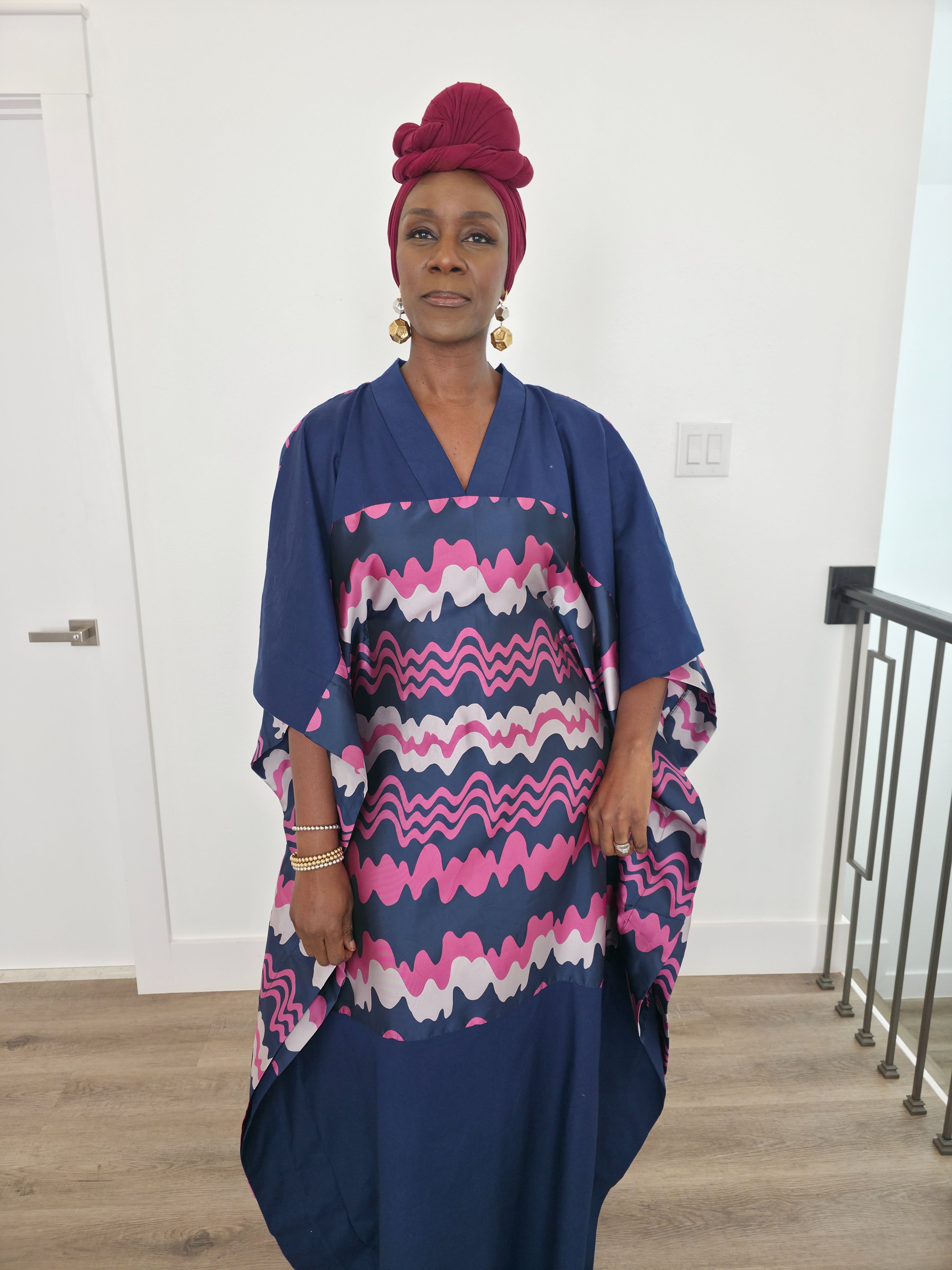 Cosmic Candy Boubou Kaftan in navy blue featuring a central horizontal panel with pink and lavender wavy patterns and a V-neck collar.