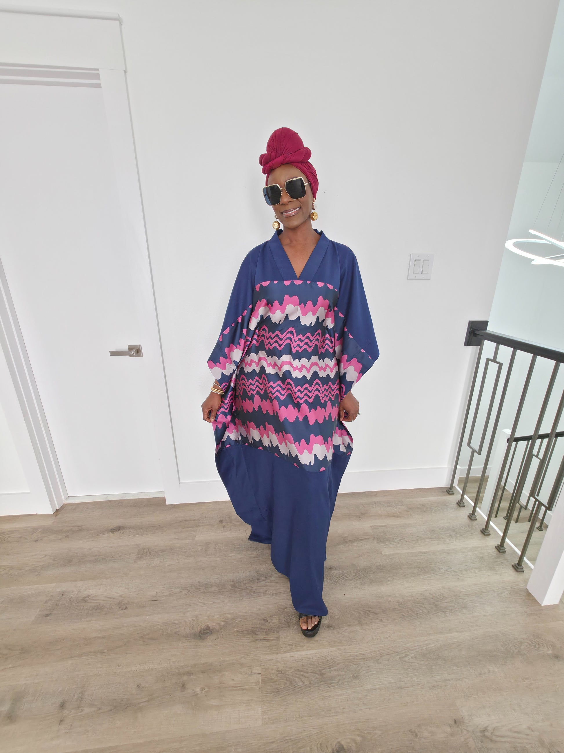 Cosmic Candy Boubou Kaftan in navy blue featuring a central horizontal panel with pink and lavender wavy patterns and a V-neck collar. Full View