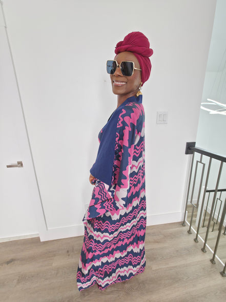 Cosmic Candy Boubou Kaftan in navy blue featuring a central horizontal panel with pink and lavender wavy patterns and a V-neck collar. Side View