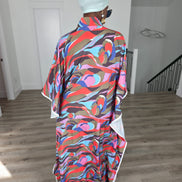 Desert Wildflower Boubou Kaftan featuring a colorful abstract organic print in earth tones, blue, and pink with a mint green headwrap. Back View