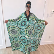 Patterned Boubou Kaftan featuring a green and black concentric circular print, a solid black V-neckline, and a wide-wing silhouette.