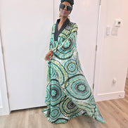 Patterned Boubou Kaftan featuring a green and black concentric circular print, a solid black V-neckline, and a wide-wing silhouette.