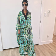 Patterned Boubou Kaftan featuring a green and black concentric circular print, a solid black V-neckline, and a wide-wing silhouette.