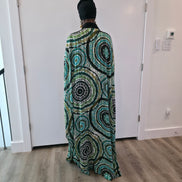 Patterned Boubou Kaftan featuring a green and black concentric circular print, a solid black V-neckline, and a wide-wing silhouette.
