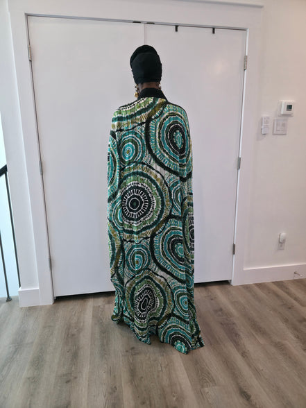 Patterned Boubou Kaftan featuring a green and black concentric circular print, a solid black V-neckline, and a wide-wing silhouette.