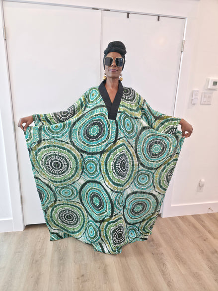 Patterned Boubou Kaftan featuring a green and black concentric circular print, a solid black V-neckline, and a wide-wing silhouette.