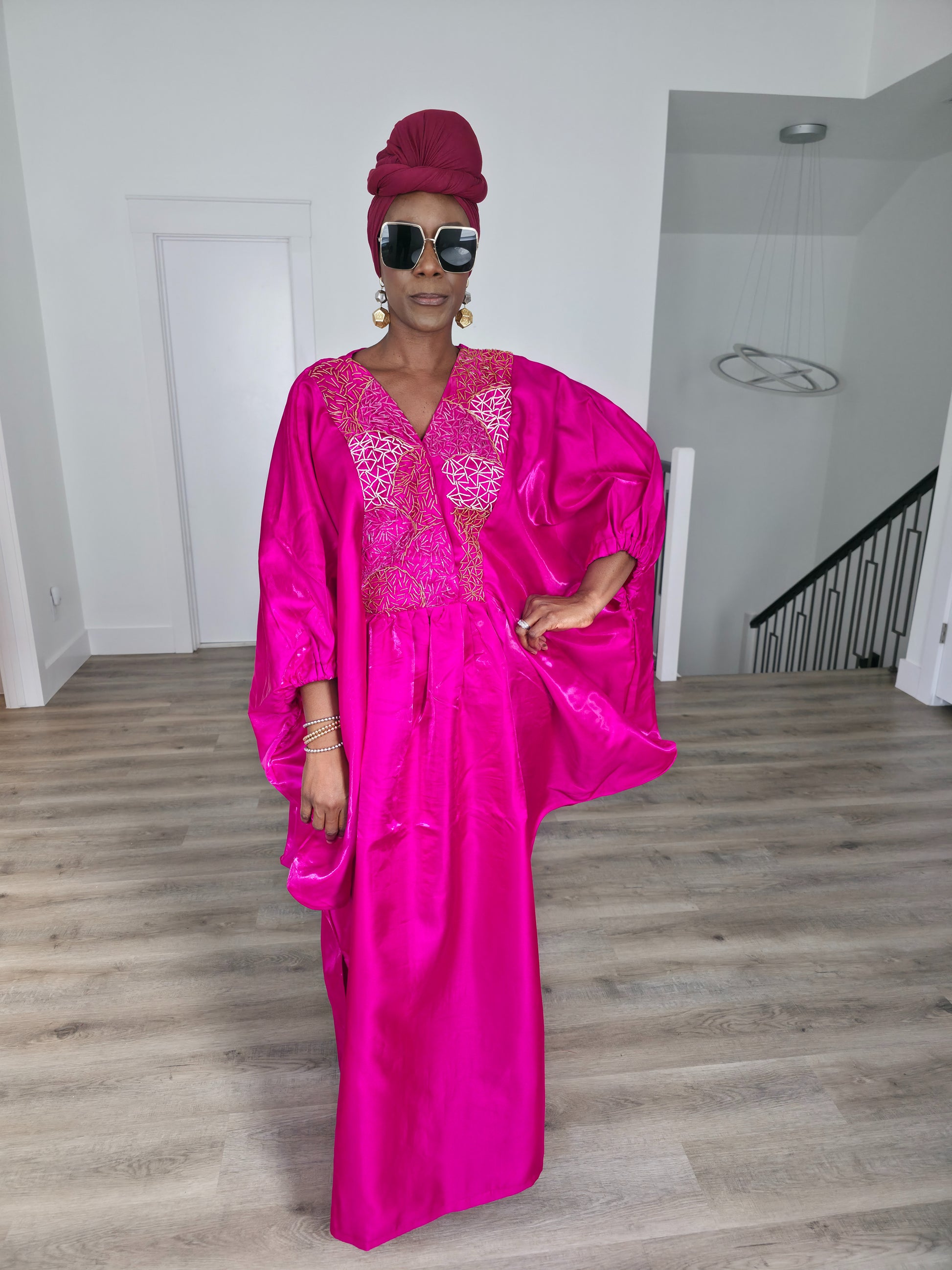 Fuchsia Brilliance Boubou Kaftan in deep pink silk-satin with an intricate gold embroidered V-neckline. - Front View