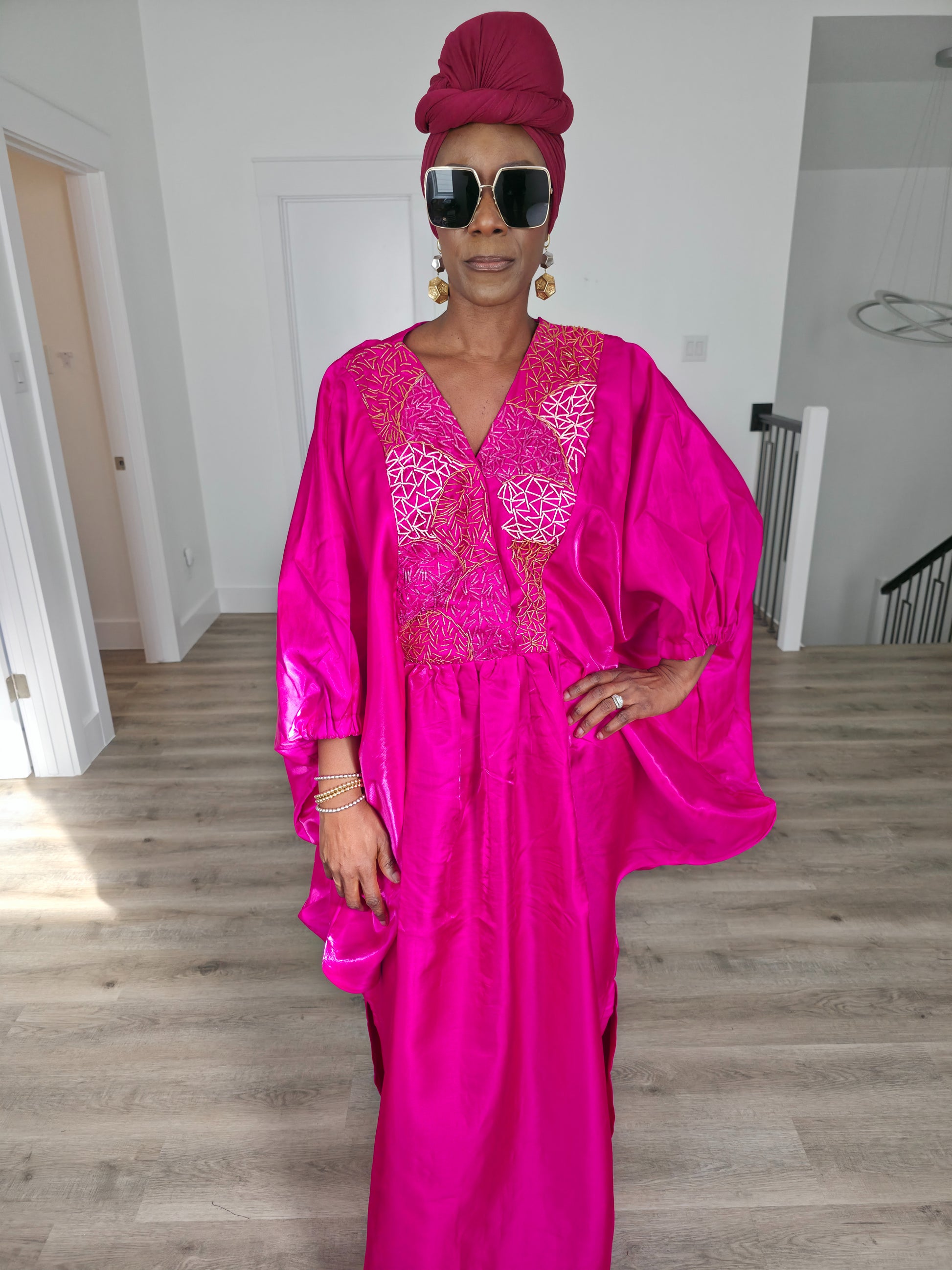 Fuchsia Brilliance Boubou Kaftan in deep pink silk-satin with an intricate gold embroidered V-neckline. Close Up