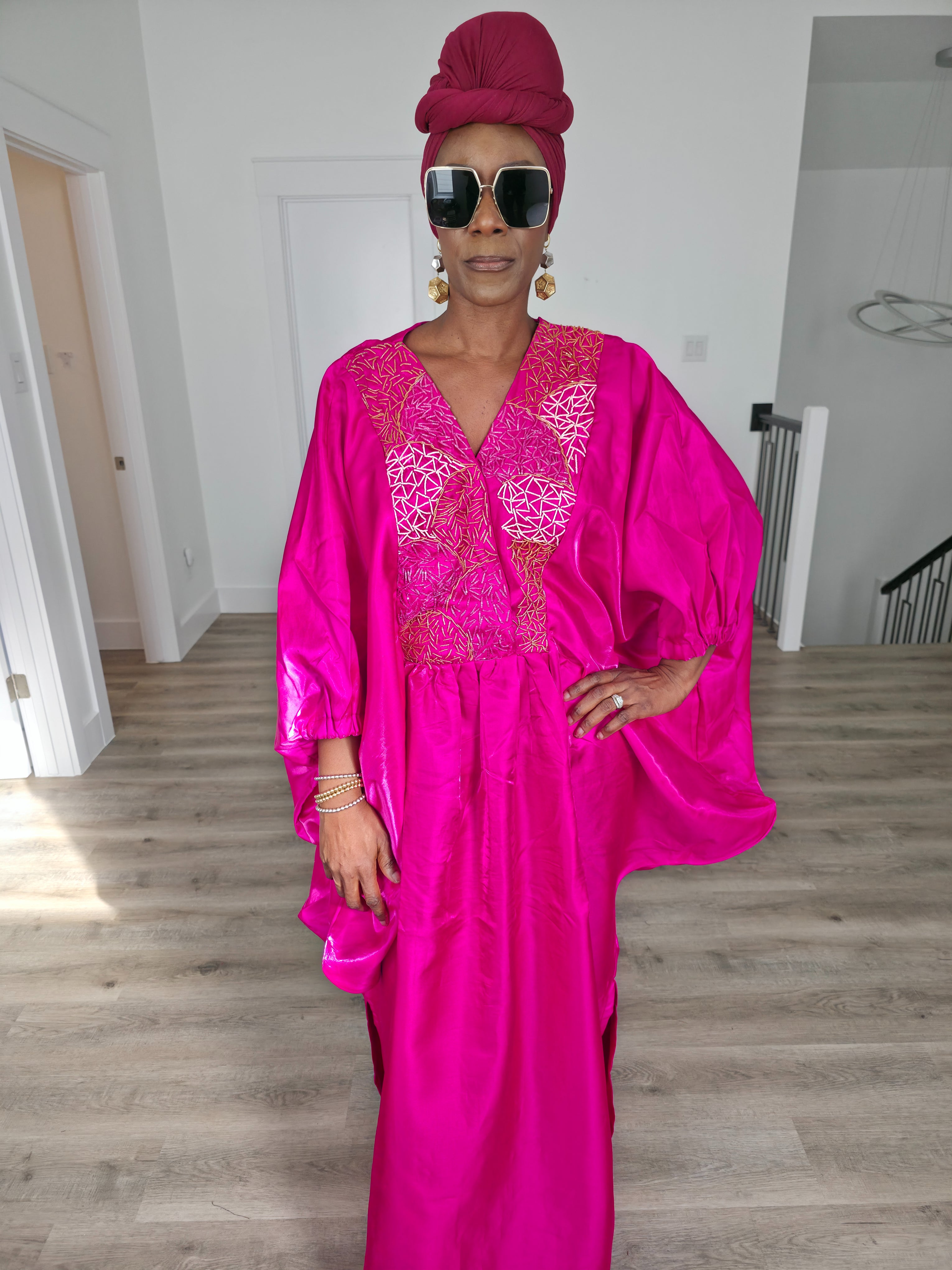 Fuchsia Brilliance Boubou Kaftan in deep pink silk-satin with an intricate gold embroidered V-neckline. Close Up
