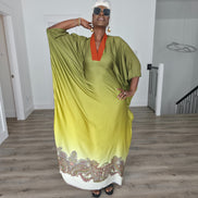 Gilded Olive Boubou Kaftan featuring an olive green and yellow gradient design with an orange V-neck collar and intricate paisley patterns along the hem. Front View