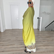 Gilded Olive Boubou Kaftan featuring an olive green and yellow gradient design with an orange V-neck collar and intricate paisley patterns along the hem. Side View