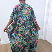 Green floral boubou kaftan featuring a vibrant pink and blue botanical pattern with a flowing, floor-length silhouette -BackView