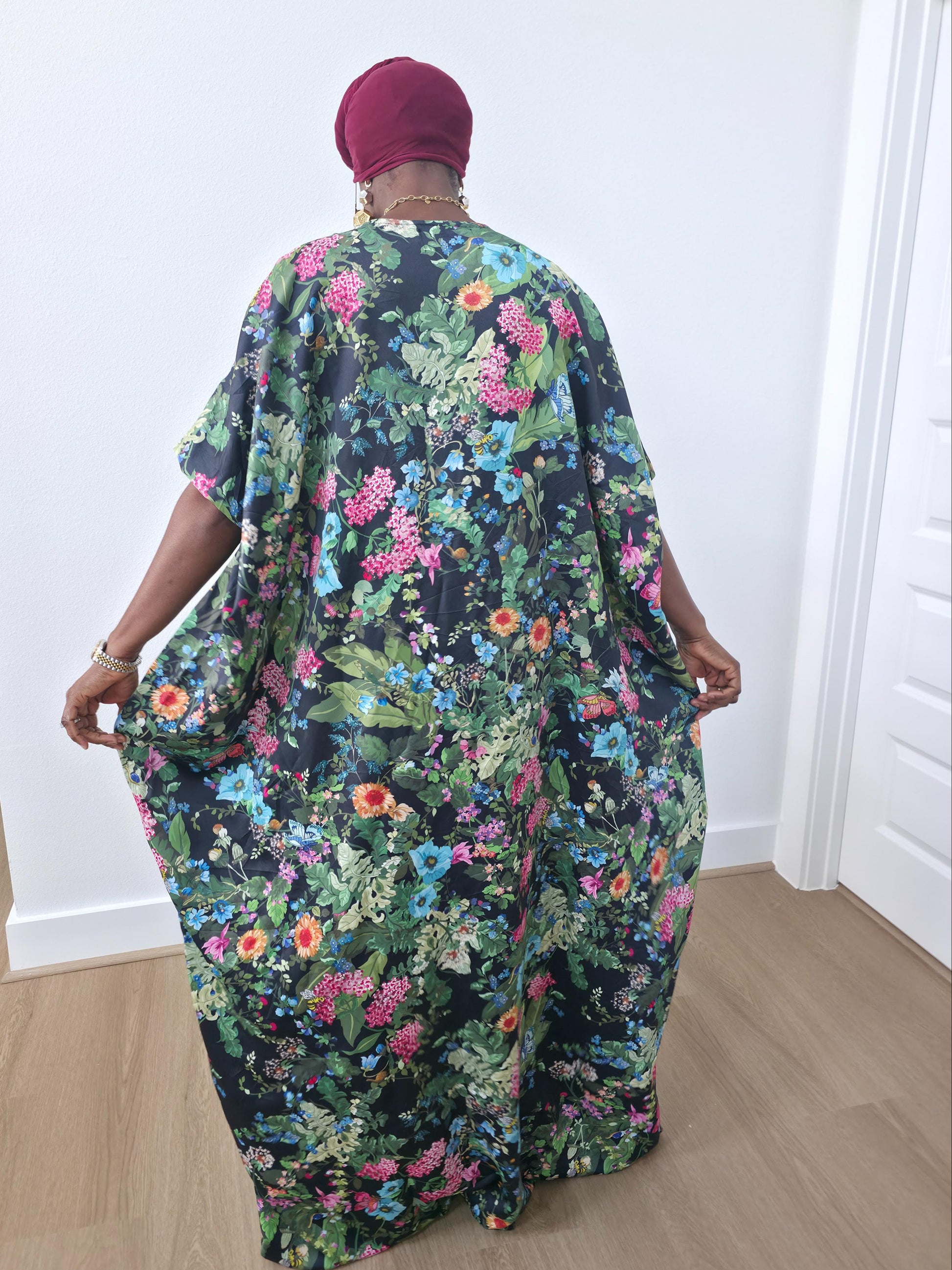 Green floral boubou kaftan featuring a vibrant pink and blue botanical pattern with a flowing, floor-length silhouette -BackView