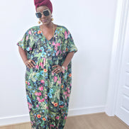 Green floral boubou kaftan featuring a vibrant pink and blue botanical pattern with a flowing, floor-length silhouette.-Front View