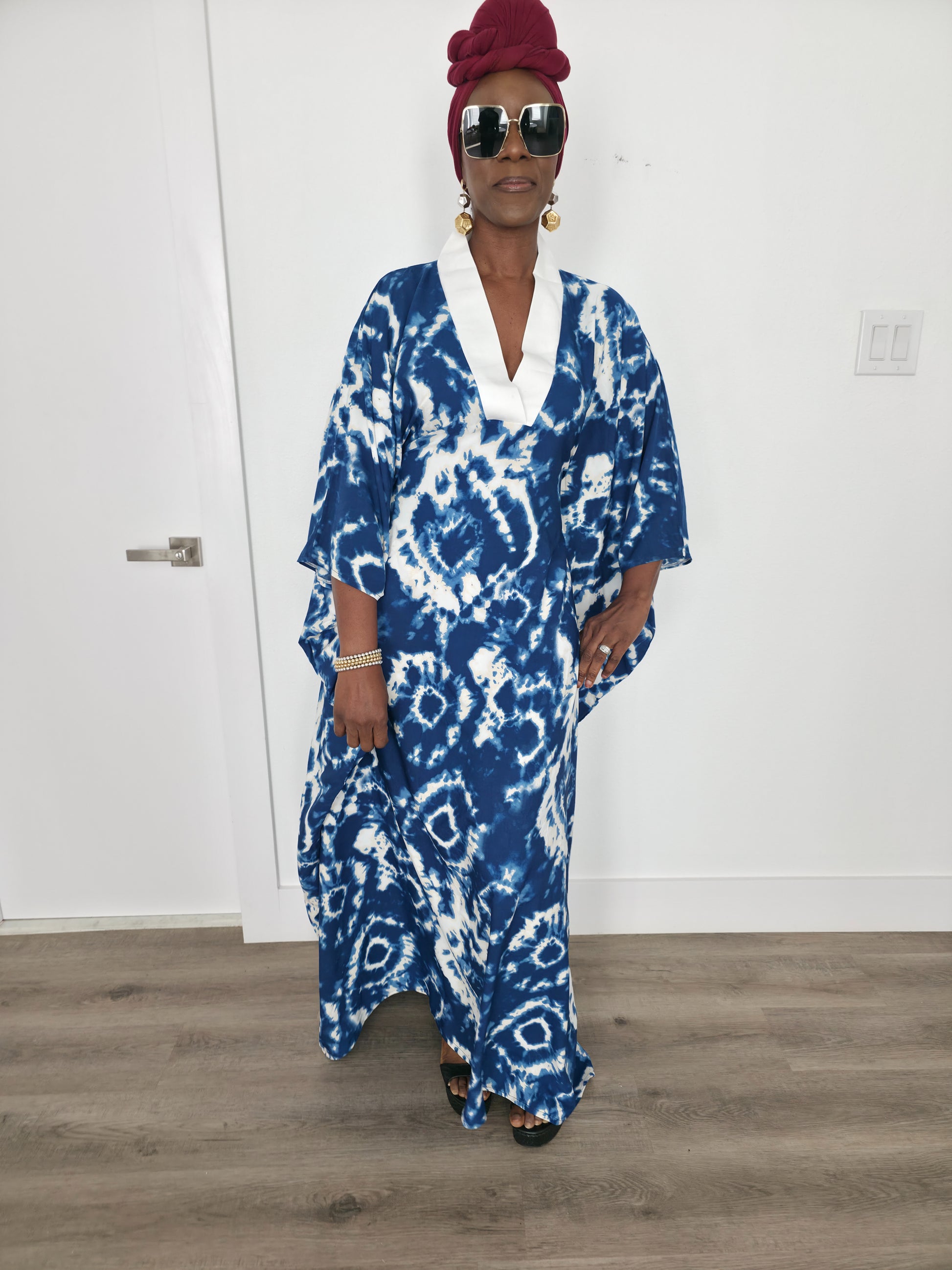 Ink & Alabaster Boubou Kaftan featuring a deep blue and white tie-dye circular pattern with a crisp white V-neck collar.