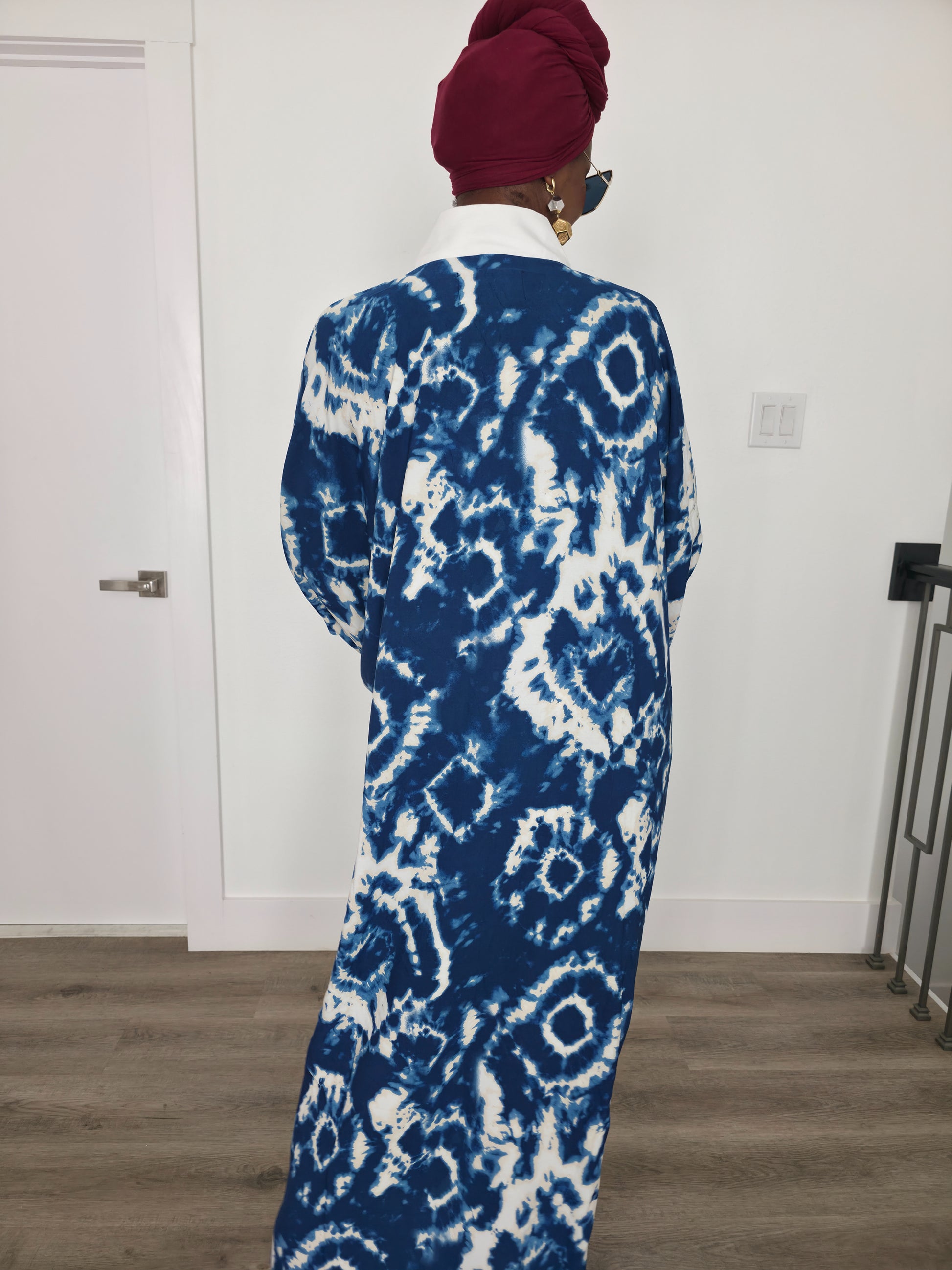 Ink & Alabaster Boubou Kaftan featuring a deep blue and white tie-dye circular pattern with a crisp white V-neck collar. Back View