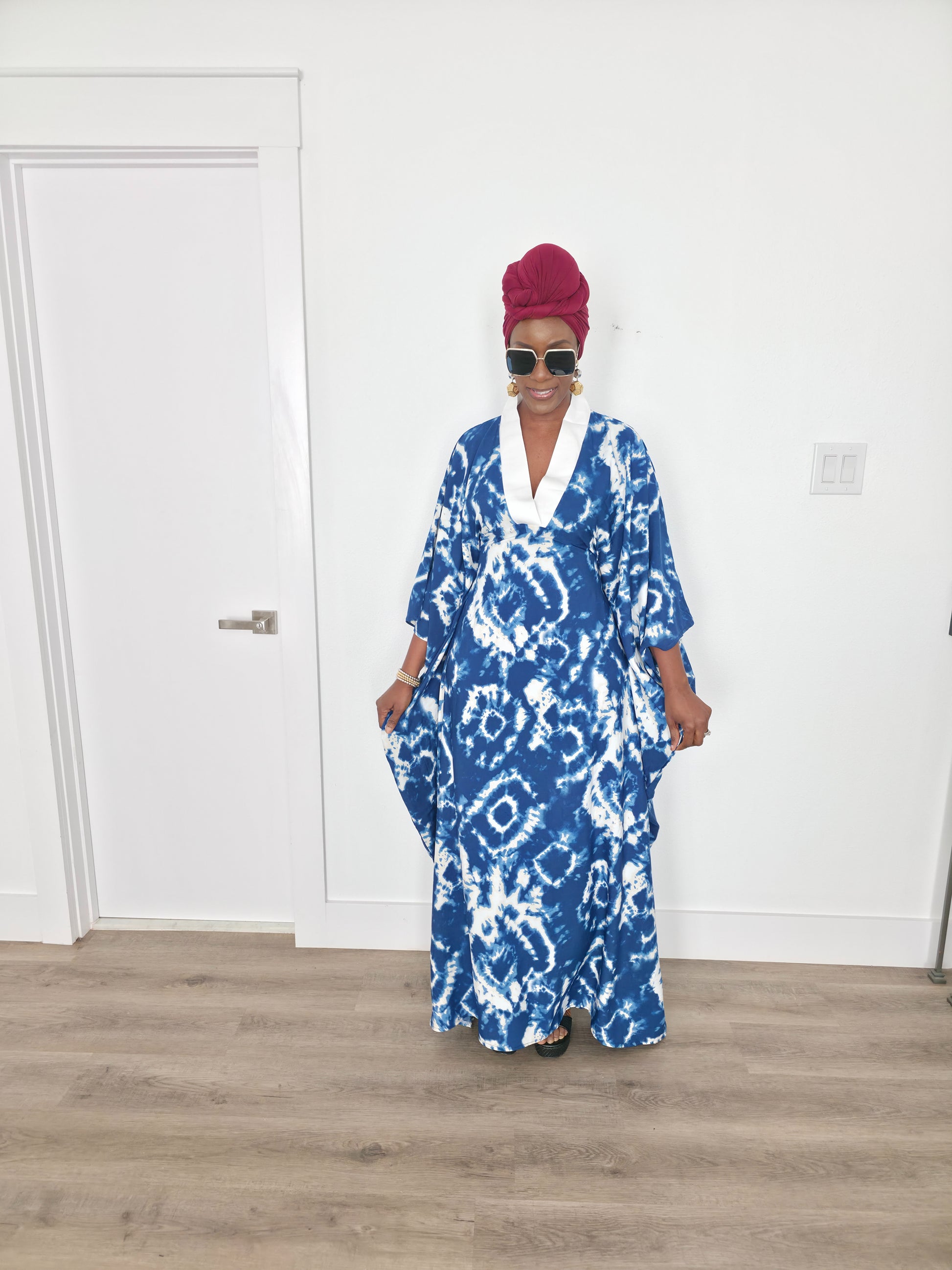 Ink & Alabaster Boubou Kaftan featuring a deep blue and white tie-dye circular pattern with a crisp white V-neck collar.