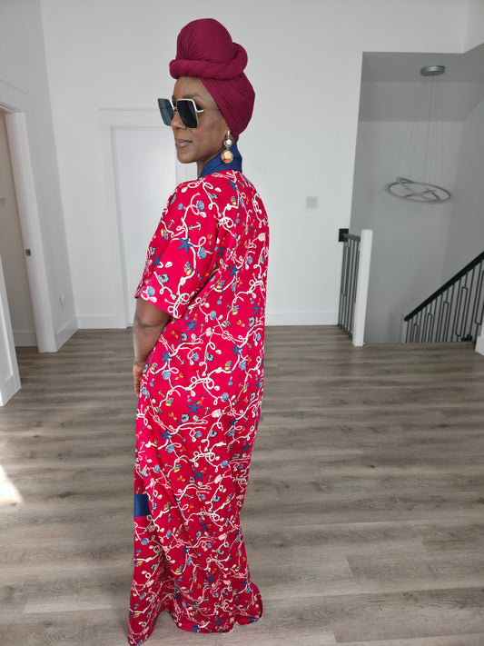 Midnight Poppy Boubou Kaftan in deep red with a white and blue floral print, featuring a navy blue collar and matching burgundy headwrap. Side back view
