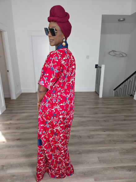 Midnight Poppy Boubou Kaftan in deep red with a white and blue floral print, featuring a navy blue collar and matching burgundy headwrap. Side back view
