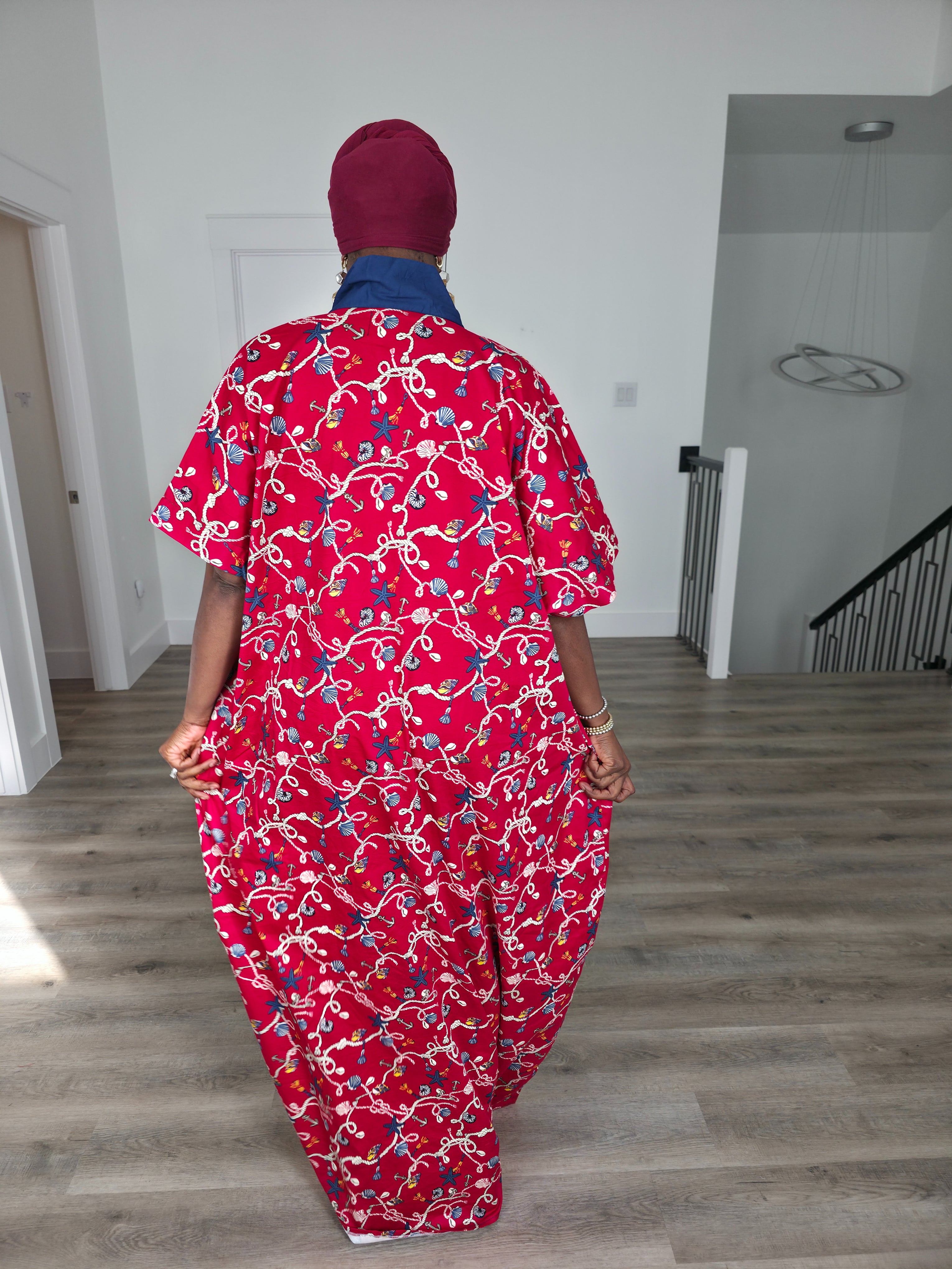 Midnight Poppy Boubou Kaftan in deep red with a white and blue floral print, featuring a navy blue collar and matching burgundy headwrap. Back View