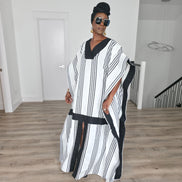 Obsidian Grid Boubou Kaftan featuring a black and white vertical stripe pattern with bold black structural borders and a matching black headwrap. Front View