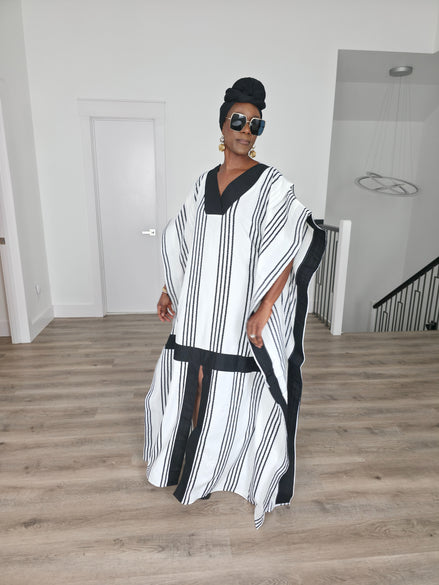 Obsidian Grid Boubou Kaftan featuring a black and white vertical stripe pattern with bold black structural borders and a matching black headwrap. Front View