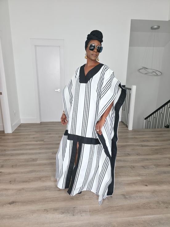 Obsidian Grid Boubou Kaftan featuring a black and white vertical stripe pattern with bold black structural borders and a matching black headwrap. Front View