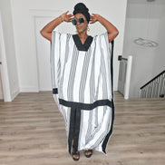 Obsidian Grid Boubou Kaftan featuring a black and white vertical stripe pattern with bold black structural borders and a matching black headwrap. Women's Wear