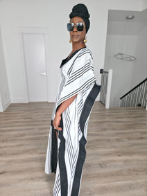 Obsidian Grid Boubou Kaftan featuring a black and white vertical stripe pattern with bold black structural borders and a matching black headwrap. Side View