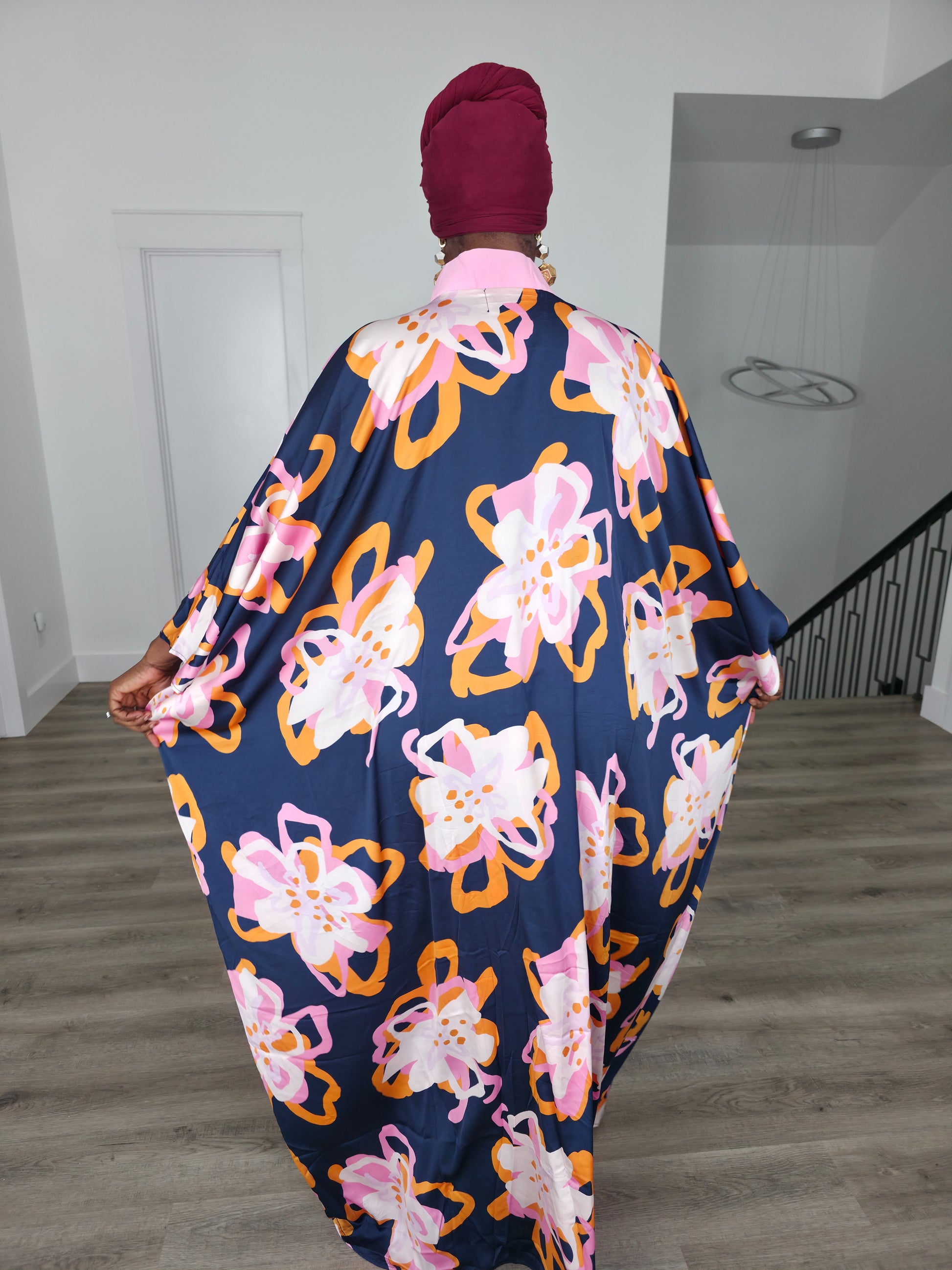 Painted Twilight Boubou Kaftan in deep navy blue featuring large, abstract pink and orange floral prints with a soft pink V-neck collar. Back View