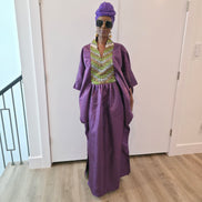 Luxury purple Boubou Kaftan featuring a heavily beaded green and gold bodice, wide sleeves, and a matching purple headwrap.