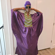 Luxury purple Boubou Kaftan featuring a heavily beaded green and gold bodice, wide sleeves, and a matching purple headwrap.