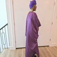Luxury purple Boubou Kaftan featuring a heavily beaded green and gold bodice, wide sleeves, and a matching purple headwrap.