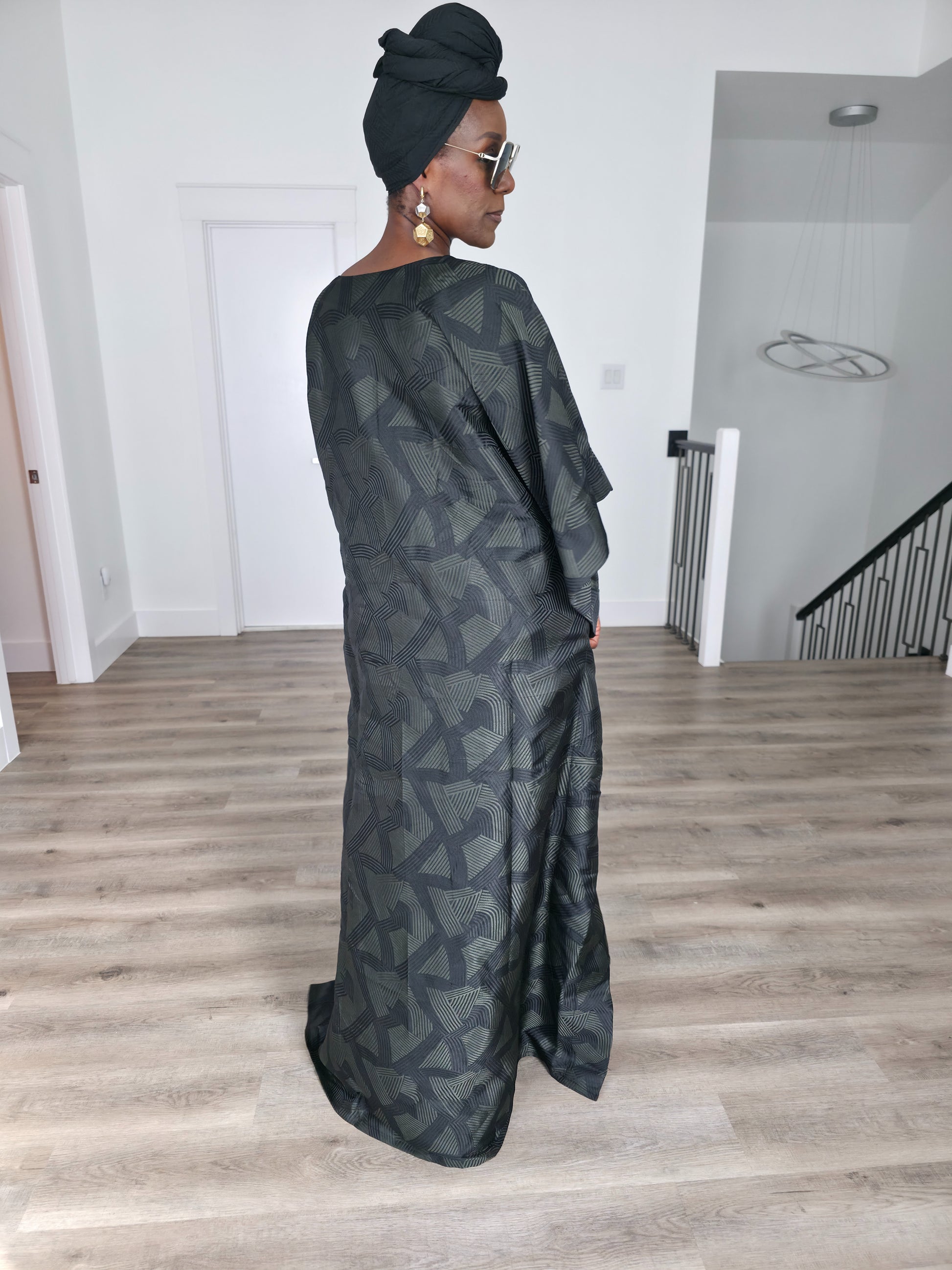 Shadowed Flint Boubou Kaftan featuring a dark grey and black geometric abstract print with a matching black headwrap. Back View