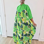 Kaftan featuring a floor-length flowing gown with a structured green bodice and a vibrant, multi-tonal botanical print.