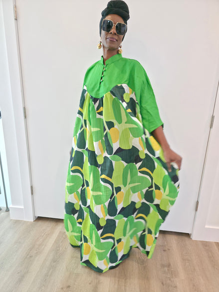 Kaftan featuring a floor-length flowing gown with a structured green bodice and a vibrant, multi-tonal botanical print.
