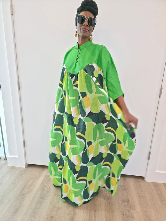 Kaftan featuring a floor-length flowing gown with a structured green bodice and a vibrant, multi-tonal botanical print.