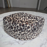 Afrocentric Kufi cap featuring a bold leopard animal print on a textured velvet fabric with a foldable, structured silhouette.